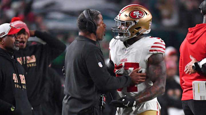 Dec 3, 2023; Philadelphia, Pennsylvania, USA; San Francisco 49ers linebacker Dre Greenlaw (57) talks a with a coach after being ejected against the Philadelphia Eagles during the third quarter at Lincoln Financial Field. Mandatory Credit: Eric Hartline-Imagn Images