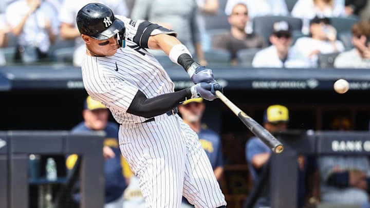 Mar 29, 2025; Bronx, New York, USA; New York Yankees right fielder Aaron Judge (99) hits a solo home run in the first inning against the Milwaukee Brewers at Yankee Stadium. 