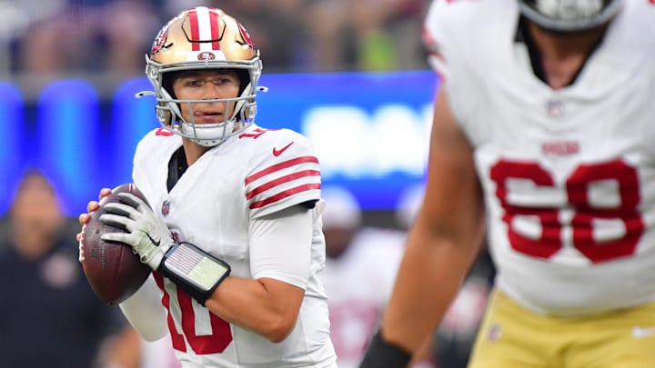 49ers quarterback Mac Jones drops back to pass against the Rams during the first half at SoFi Stadium. 49ers quarterback Mac Jones drops back to pass against the Rams during the first half at SoFi Stadium.