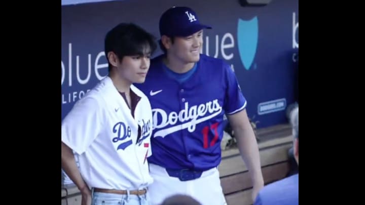 The BTS star, on the left, also threw out the first pitch.