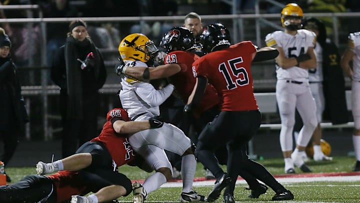 Gilbert's linebacker Will Hawthorne (43) and Gilbert's tight end/linebacker Bowen Kruse (42) take down Waverly-Shell Rock's wide receiver Jayden Stephens (24) after making a catch during the fourth quarter in the 4A first round high school football playoff at Gilbert High School onFriday, Nov. 1, 2024, in Gilbert, Iowa.