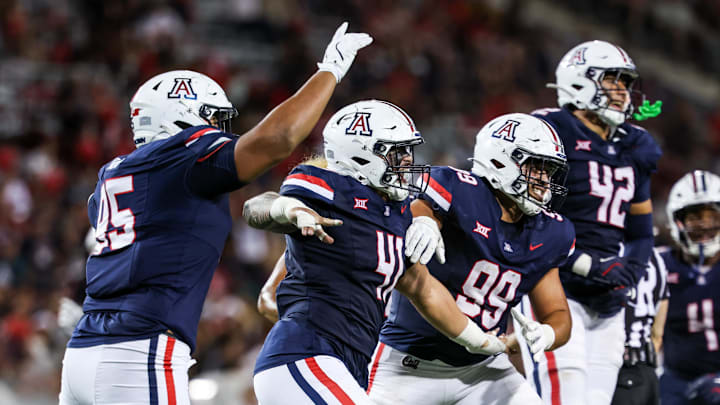 Aug 30, 2025; Tucson, Arizona, USA; Arizona Wildcats defensive lineman Leroy Palu (95), defensive lineman Julian Savaiinaea (41), defensive lineman Mays Pese (99), and defensive lineman Dominic Lolesio (42) all celebrate after they intercept the ball from the Hawaii Rainbow Warriors during the third quarter at Arizona Stadium. Mandatory Credit: Aryanna Frank-Imagn Images Aug 30, 2025; Tucson, Arizona, USA; Arizona Wildcats defensive lineman Leroy Palu (95), defensive lineman Julian Savaiinaea (41), defensive lineman Mays Pese (99), and defensive lineman Dominic Lolesio (42) all celebrate after they intercept the ball from the Hawaii Rainbow Warriors during the third quarter at Arizona Stadium. Mandatory Credit: Aryanna Frank-Imagn Images