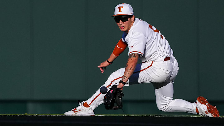Texas Longhorns infielder Ethan Mendoza (5) reaches for a ground ball during the annual Texas baseball alumni game at UFCU Disch-Falk Field on Saturday, Feb. 1, 2025.