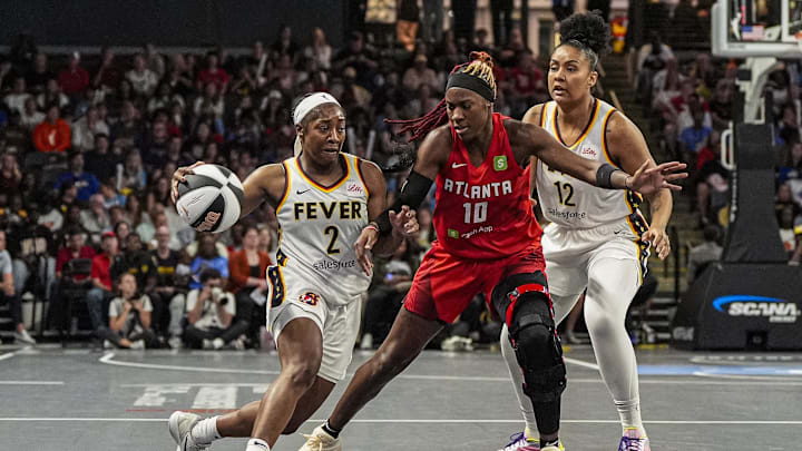Jun 10, 2025; College Park, Georgia, USA; Indiana Fever guard Aari McDonald (2) dribbles against Atlanta Dream guard Rhyne Howard (10) during the second half at Gateway Center Arena at College Park. Mandatory Credit: Dale Zanine-Imagn Images