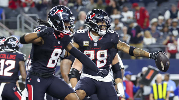 Nov 18, 2024; Arlington, Texas, USA; Houston Texans running back Joe Mixon (28) celebrates with Houston Texans wide receiver John Metchie III (8) after scoring a touchdown during the second half against the Dallas Cowboys at AT&T Stadium. Mandatory Credit: Kevin Jairaj-Imagn Images