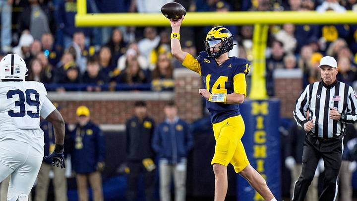Michigan quarterback Tommy Carr makes a pass against Penn State during the second half Michigan quarterback Tommy Carr makes a pass against Penn State during the second half