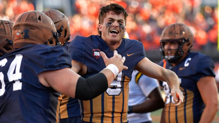 Oct 19, 2024; Champaign, Illinois, USA;  Illinois Fighting Illini quarterback Luke Altmyer (9) celebrates after scoring a touchdown against the Michigan Wolverines during the second half at Memorial Stadium. Mandatory Credit: Ron Johnson-Imagn Images
