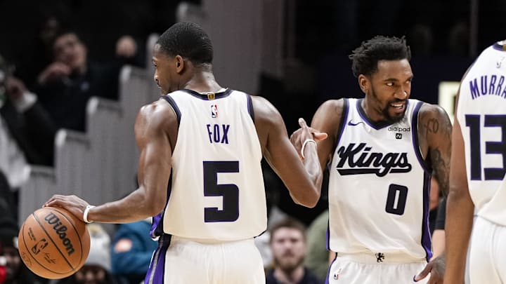 Dec 29, 2023; Atlanta, Georgia, USA; Sacramento Kings guard De'Aaron Fox (5) reacts with guard Malik Monk (0) after the Kings defeated the Atlanta Hawks at State Farm Arena. Mandatory Credit: Dale Zanine-Imagn Images