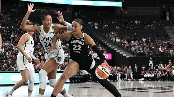 Sep 4, 2025; Las Vegas, Nevada, USA; Las Vegas Aces center A'ja Wilson (22) drives against Minnesota Lynx forward Napheesa Collier (24) in the first quarter of their game at T-Mobile Arena. Mandatory Credit: Candice Ward-Imagn Images