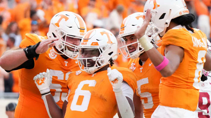 Tennessee offensive lineman Cooper Mays (63), wide receiver Bru McCoy (5), and quarterback Nico Iamaleava (8) surround running back Dylan Sampson (6) in celebration after Sampson's touchdown during an NCAA college football game against Alabama on Saturday, Oct. 19, 2024, in Knoxville. Tenn.