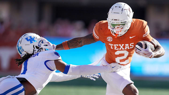 Texas Longhorns wide receiver Matthew Golden (2) stiff arms Kentucky Wildcats defensive back Maxwell Hairston (1) in the first quarter of an NCAA college football game at Darrell K Royal Texas Memorial Stadium in Austin, Texas on Saturday, Nov. 24, 2024.