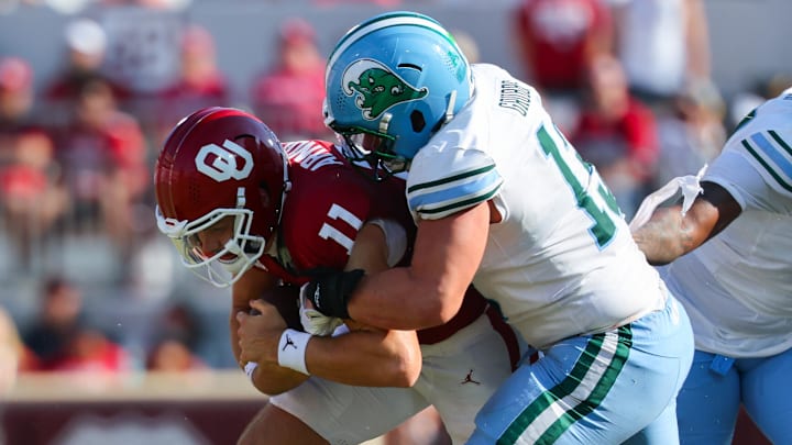 Sep 14, 2024; Norman, Oklahoma, USA; Tulane Green Wave linebacker Tyler Grubbs (13) tackles Oklahoma Sooners quarterback Jackson Arnold (11) during the game at Gaylord Family-Oklahoma Memorial Stadium.