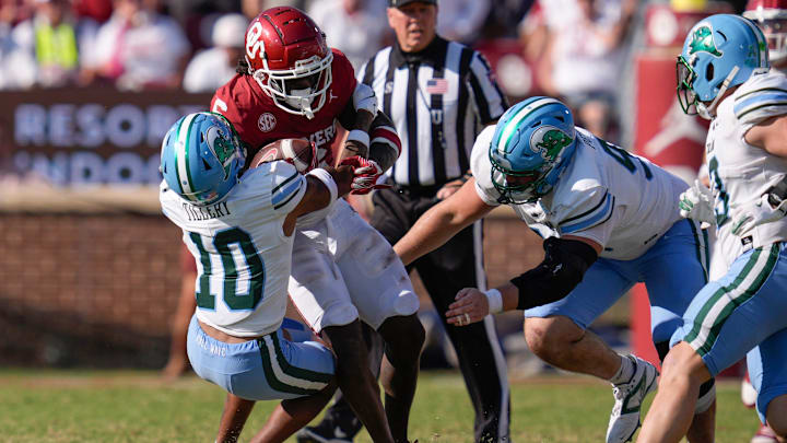 Oklahoma Sooners wide receiver Deion Burks (6) is brought down by Tulane Green Wave defensive back Lu Tillery (10) and Tulane Green Wave defensive end Parker Petersen (98) during a college football game between the University of Oklahoma Sooners (OU) and the Tulane Green Wave at Gaylord Family - Oklahoma Memorial Stadium in Norman, Okla., Saturday, Sept. 14, 2024. Oklahoma Sooners wide receiver Deion Burks (6) is brought down by Tulane Green Wave defensive back Lu Tillery (10) and Tulane Green Wave defensive end Parker Petersen (98) during a college football game between the University of Oklahoma Sooners (OU) and the Tulane Green Wave at Gaylord Family - Oklahoma Memorial Stadium in Norman, Okla., Saturday, Sept. 14, 2024.