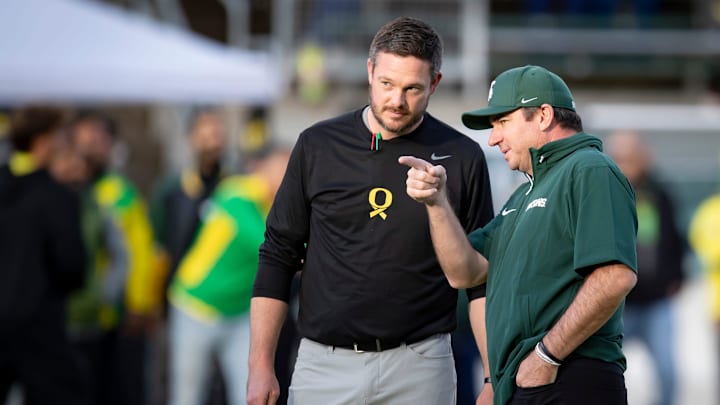 Oregon Ducks head coach Dan Lanning and Michigan State Spartans head coach Jonathan Smith talk before the game as the Ducks host the Spartans Friday, Oct. 4, 2024 at Autzen Stadium in Eugene, Ore.