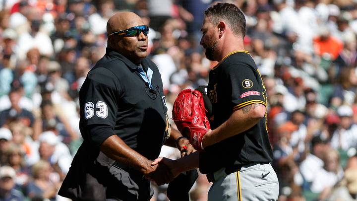 Umpire Laz Diaz (63) congratulates Kirby Yates (54) on his last game during the second inning against the Detroit Tigers at Comerica Park on Sept. 26, 2026.