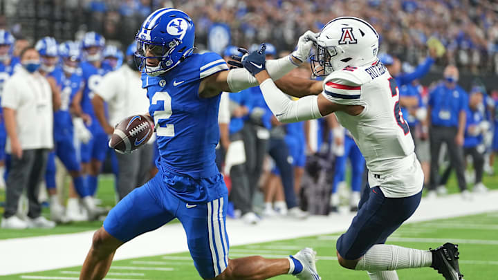Sep 4, 2021; Paradise, Nevada, USA; Brigham Young Cougars wide receiver Neil Pau'u (2) evades the tackle attempt of Arizona Wildcats cornerback Isaiah Rutherford (2) on a scoring play at Allegiant Stadium. Mandatory Credit: Stephen R. Sylvanie-Imagn Images Sep 4, 2021; Paradise, Nevada, USA; Brigham Young Cougars wide receiver Neil Pau'u (2) evades the tackle attempt of Arizona Wildcats cornerback Isaiah Rutherford (2) on a scoring play at Allegiant Stadium. Mandatory Credit: Stephen R. Sylvanie-Imagn Images