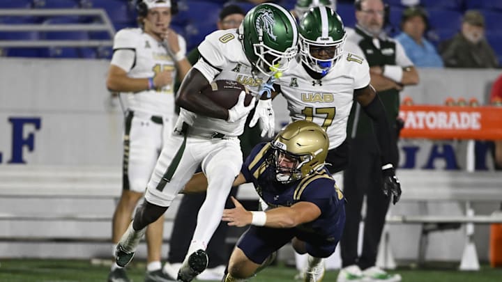 Sep 6, 2025; Annapolis, Maryland, USA; Navy Midshipmen safety Maxwell Williams (22) tackles UAB Blazers wide receiver Iverson Hook (0) on a punt return during the third quarter at Navy-Marine Corps Memorial Stadium. Mandatory Credit: Tommy Gilligan-Imagn Images Sep 6, 2025; Annapolis, Maryland, USA; Navy Midshipmen safety Maxwell Williams (22) tackles UAB Blazers wide receiver Iverson Hook (0) on a punt return during the third quarter at Navy-Marine Corps Memorial Stadium. Mandatory Credit: Tommy Gilligan-Imagn Images