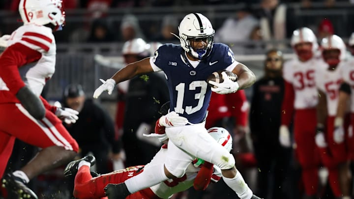 Penn State Nittany Lions running back Kaytron Allen (13) runs with the ball while trying to avoid a tackle from Nebraska Cornhuskers defensive back DeShon Singleton (8) during the second quarter at Beaver Stadium. 
