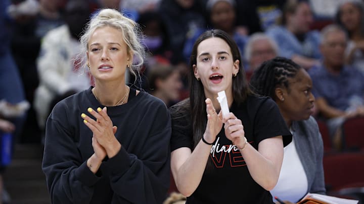 Jun 7, 2025; Chicago, Illinois, USA; Injured Indiana Fever guard Sophie Cunningham (8) and guard Caitlin Clark (22) react from the bench during the first half of a WNBA game against the Chicago Sky at United Center. Mandatory Credit: Kamil Krzaczynski-Imagn Images