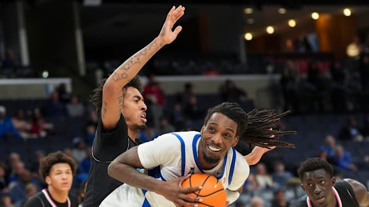 Memphis' Aaron Bradshaw (11) looks to pass the ball as Florida Atlantic's Devin Williams (1) guards him during the game between the University of Memphis and FAU at FedExForum in Memphis, Tenn., on January 29, 2026.