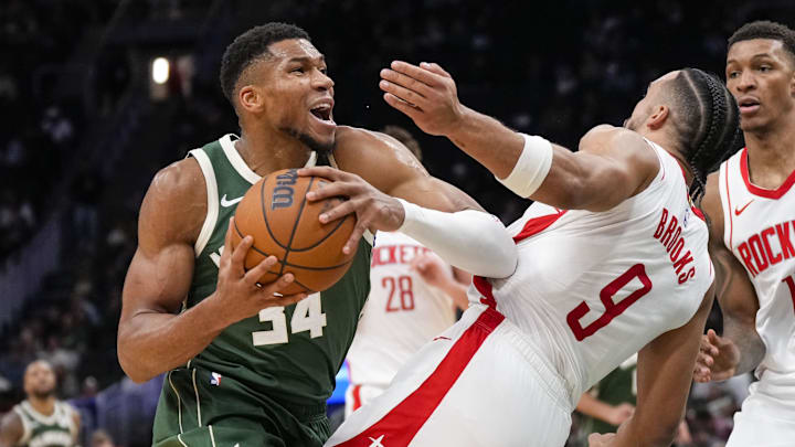 Nov 18, 2024; Milwaukee, Wisconsin, USA;  Milwaukee Bucks forward Giannis Antetokounmpo (34) drives for the basket against Houston Rockets forward Dillon Brooks (9) during the third quarter at Fiserv Forum. Mandatory Credit: Jeff Hanisch-Imagn Images