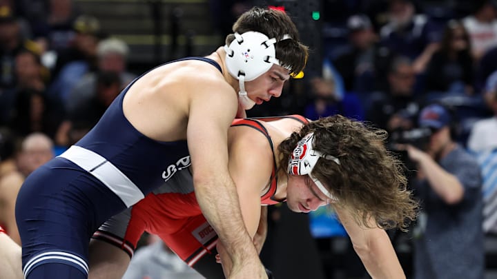 Mar 7, 2026; University Park, PA, USA; Penn State’s PJ Duke (left) grabs the wrist of Ohio State’s Brandon Cannon (right) while wrestling in a 157-pound bout during the quarterfinals of the Big Ten Wrestling Championships at Bryce Jordan Center. Mandatory Credit: Matthew O'Haren-Imagn Images