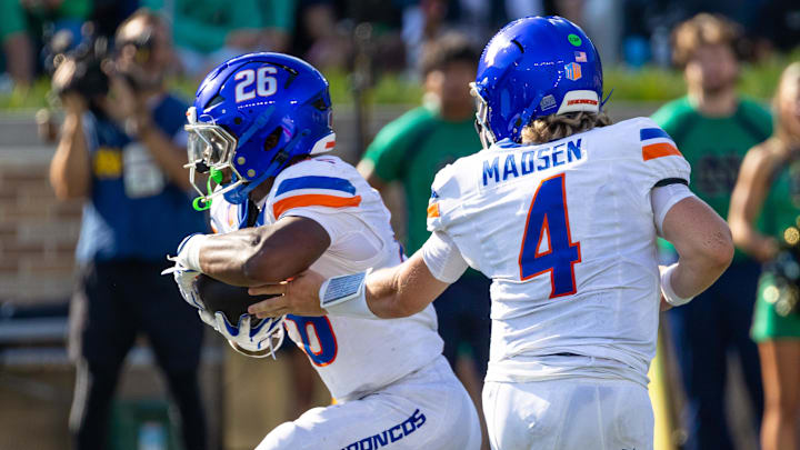 Boise State quarterback Maddux Madsen hands off to running back Sire Gaines.