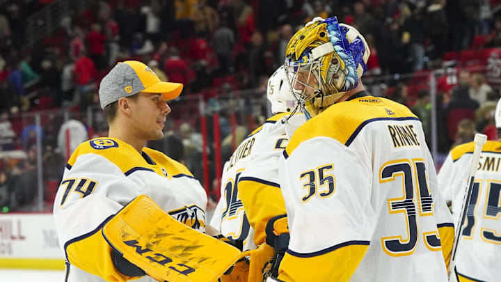 Nov 29, 2019; Raleigh, NC, USA;  Nashville Predators goaltender Juuse Saros (74) congratulates goaltender Pekka Rinne (35) after defeating the Carolina Hurricanes at PNC Arena. Nashville won 3-0. Mandatory Credit: James Guillory-Imagn Images