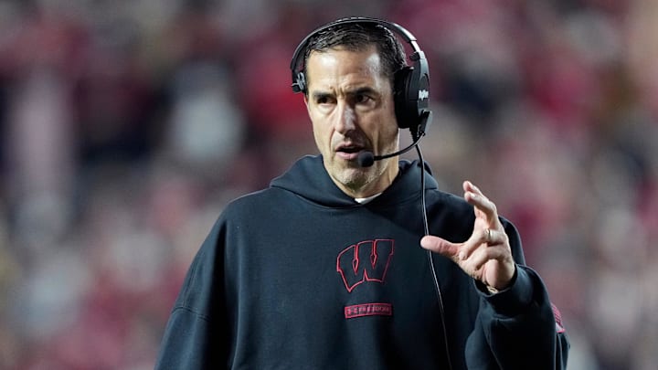 Nov 22, 2025; Madison, Wisconsin, USA; Wisconsin Badgers head coach Luke Fickell talks to his team during the second half against the Illinois Fighting Illini at Camp Randall Stadium.