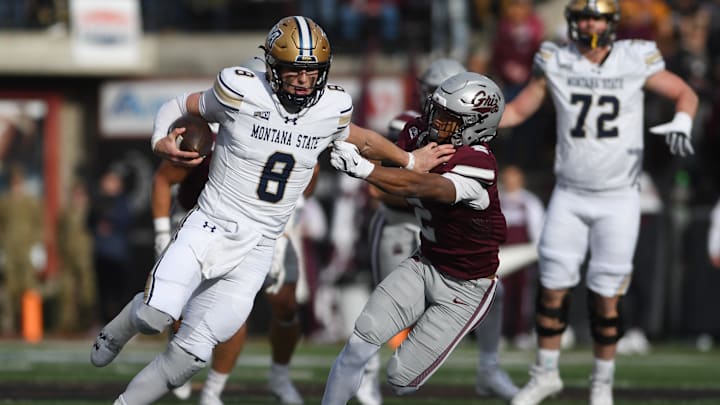 Montana State Bobcats quarterback Justin Lamson (8) carries the ball against Montana Grizzlies safety Micah Harper (2) Montana State Bobcats quarterback Justin Lamson (8) carries the ball against Montana Grizzlies safety Micah Harper (2)