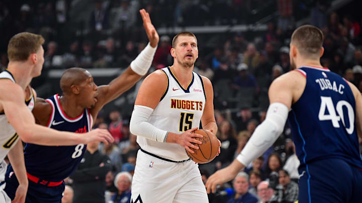 Apr 24, 2025; Inglewood, California, USA; Denver Nuggets center Nikola Jokic (15) controls the ball against Los Angeles Clippers center Ivica Zubac (40) and guard Kris Dunn (8) during the first half of game three in the first round for the 2024 NBA Playoffs at Intuit Dome. Mandatory Credit: Gary A. Vasquez-Imagn Images