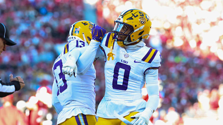 LSU Tigers defensive back A.J. Haulcy and Louisiana State Tigers safety Tamarcus Cooley react during the first half against the Oklahoma Sooners at Gaylord Family-Oklahoma Memorial Stadium. 
