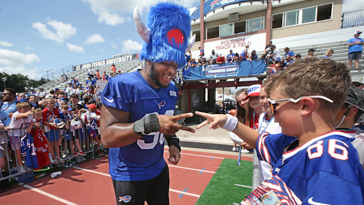 Bills defensive tackle DeWayne Carter looses a game of 'rock, paper, sissors' to fan Isaac Howlett, 11, Rochester, as he signs autographs at the end of day three. The pair were playing for Carter's wristbands, which Howlett won.