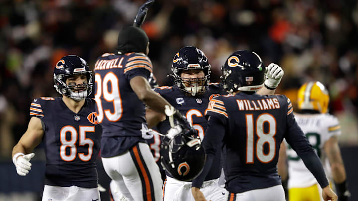 Chicago Bears quarterback Caleb Williams (18) is swarmed by teammates after throwing the game-winning touchdown pass in overtime against the Green Bay Packers during their football game Saturday, December 20, 2025, at Soldier Field in Chicago, Illinois.