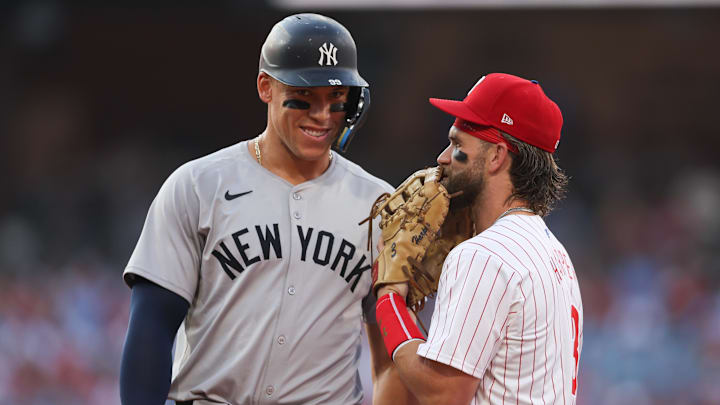 Jul 30, 2024; Philadelphia, Pennsylvania, USA; New York Yankees outfielder Aaron Judge (99) with Philadelphia Phillies first base Bryce Harper (3) on first base after his single during the first inning at Citizens Bank Park. Mandatory Credit: Bill Streicher-Imagn Images