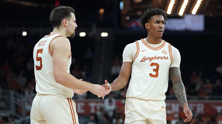 Texas Longhorns guard Dailyn Swain is congratulated by forward Camden Heide during the first half at Moody Center.