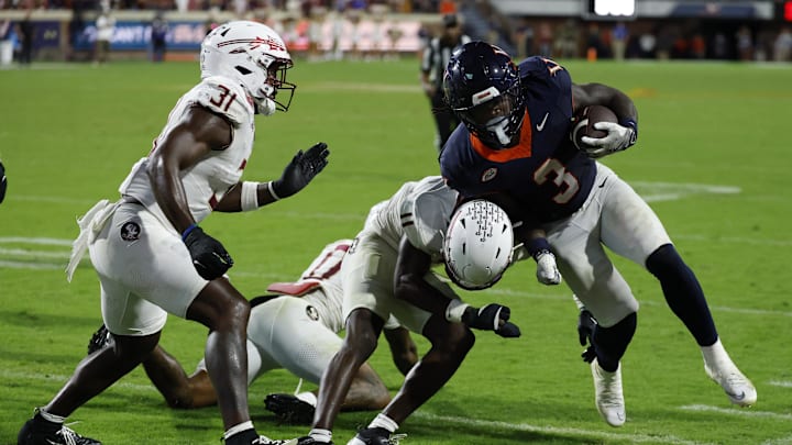 Sep 26, 2025; Charlottesville, Virginia, USA; Virginia Cavaliers running back J'Mari Taylor (3) carries the ball as Florida State Seminoles defensive back Ja'Bril Rawls (11) tackleds in the second overtime at Scott Stadium. Mandatory Credit: Geoff Burke-Imagn Images Sep 26, 2025; Charlottesville, Virginia, USA; Virginia Cavaliers running back J'Mari Taylor (3) carries the ball as Florida State Seminoles defensive back Ja'Bril Rawls (11) tackleds in the second overtime at Scott Stadium. Mandatory Credit: Geoff Burke-Imagn Images