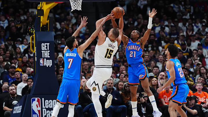 Oklahoma City Thunder forward Chet Holmgren (7) and guard Aaron Wiggins (21) and  guard Ajay Mitchell (25) defend on Denver Nuggets center Nikola Jokic (15) in the second quarter at Ball Arena. Mandatory Credit: Ron Chenoy-Imagn Images