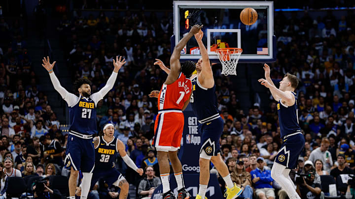 Los Angeles Clippers guard Amir Coffey (7) passes the ball as Denver Nuggets center Nikola Jokic (15) and guard Jamal Murray (27) and guard Christian Braun (0) defend in the third quarter during game two of first round for the 2025 NBA Playoffs at Ball Arena. Mandatory Credit: Isaiah J. Downing-Imagn Images
