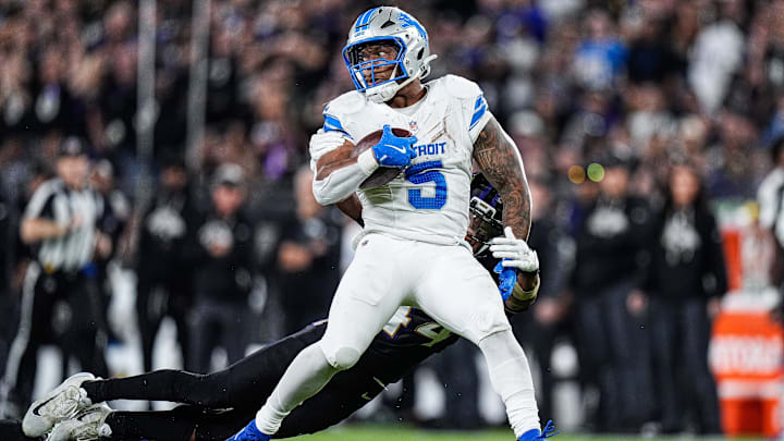 Detroit Lions running back David Montgomery (5) runs against Baltimore Ravens cornerback Marlon Humphrey (44) and defensive tackle Broderick Washington (96) during the second half at M&T Bank Stadium in Baltimore, Md. on Monday, Sept. 22, 2025.