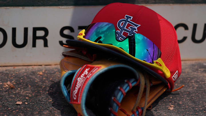 Mar 20, 2018; Jupiter, FL, USA; A St. Louis Cardinals hat with sunglasses sits on a glove in the dugout during a spring training game against the New York Mets at Roger Dean Stadium. Mandatory Credit: Jasen Vinlove-Imagn Images