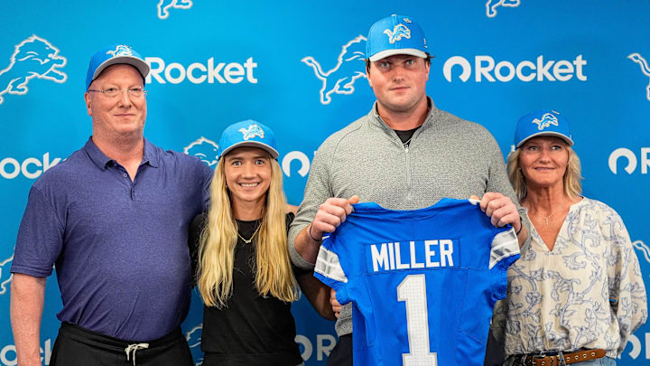 Detroit Lions first round draft Blake Miller, center, poses for a photo with his father Chris Miller, left, girlfriend Kylie Jicha, center left, and mother Karen Miller at his introductory press conference at Meijer Performance Center in Allen Park on Friday, April 24, 2026.