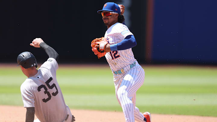 New York Mets shortstop Francisco Lindor attempts to turn a double play after forcing out Yankees left fielder Cody Bellinger.
