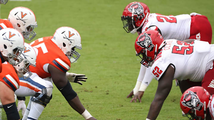 Oct 10, 2020; Charlottesville, Virginia, USA; The Virginia Cavaliers offense lines up against the North Carolina State Wolfpack defense in the fourth quarter at Scott Stadium. Mandatory Credit: Geoff Burke-Imagn Images Oct 10, 2020; Charlottesville, Virginia, USA; The Virginia Cavaliers offense lines up against the North Carolina State Wolfpack defense in the fourth quarter at Scott Stadium. Mandatory Credit: Geoff Burke-Imagn Images