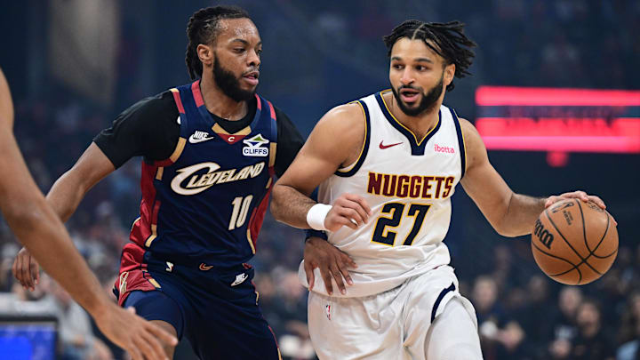 Jan 2, 2026; Cleveland, Ohio, USA; Denver Nuggets guard Jamal Murray (27) drives on Cleveland Cavaliers guard Darius Garland (10) during the first half at Rocket Arena. Mandatory Credit: David Dermer-Imagn Images