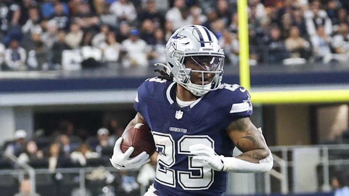 Dallas Cowboys running back Rico Dowdle runs with the ball during the game against the Washington Commanders.