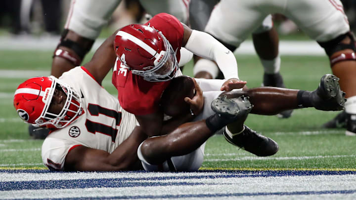 Alabama quarterback Jalen Milroe (4) is taken down by Georgia linebacker Jalon Walker (11) during the second half of the SEC Championship game at Mercedes-Benz Stadium in Atlanta, on Saturday, Dec. 2, 2023. Alabama won 27-24.