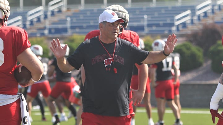 Wisconsin offensive line coach Jack Bicknell Jr. talks with his players during practice on Sunday Aug. 6, 2023 at Pioneer Stadium in Platteville, Wis.