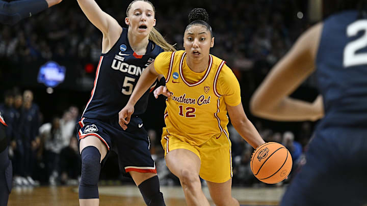 Apr 1, 2024; Portland, OR, USA; USC Trojans guard JuJu Watkins (12) drives to the basket during the second half against UConn Huskies guard Paige Bueckers (5) in the finals of the Portland Regional of the NCAA Tournament at the Moda Center.
