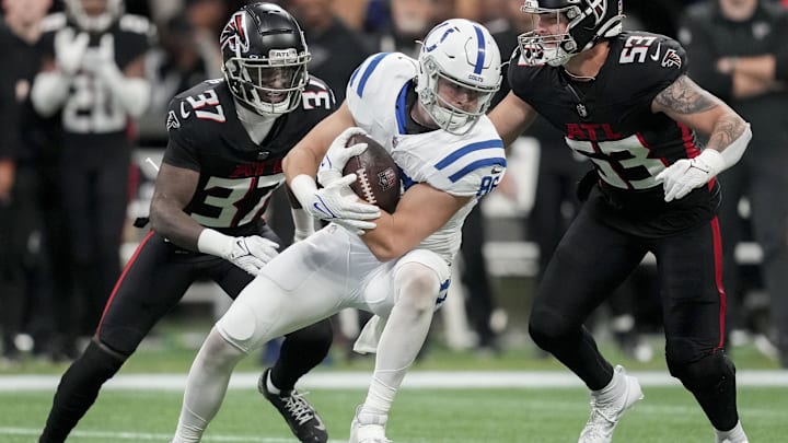 Dec 24, 2023; Atlanta, Georgia, USA; Indianapolis Colts tight end Will Mallory (86) brings in a pass while being guarded by Atlanta Falcons safety DeMarcco Hellams (37) and inebacker Nate Landman (53) on during a game at Mercedes-Benz Stadium. Mandatory Credit: Bob Scheer-Imagn Images